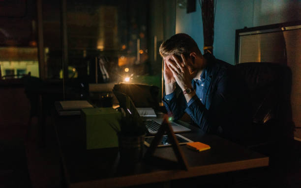 Photo of businessman working late night in the office